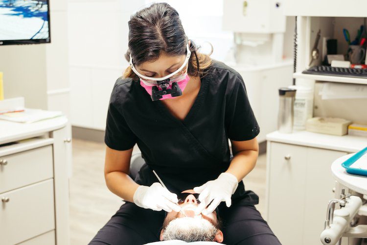 A dental assistant at New Look Dental in West Kelowna uses the Wand