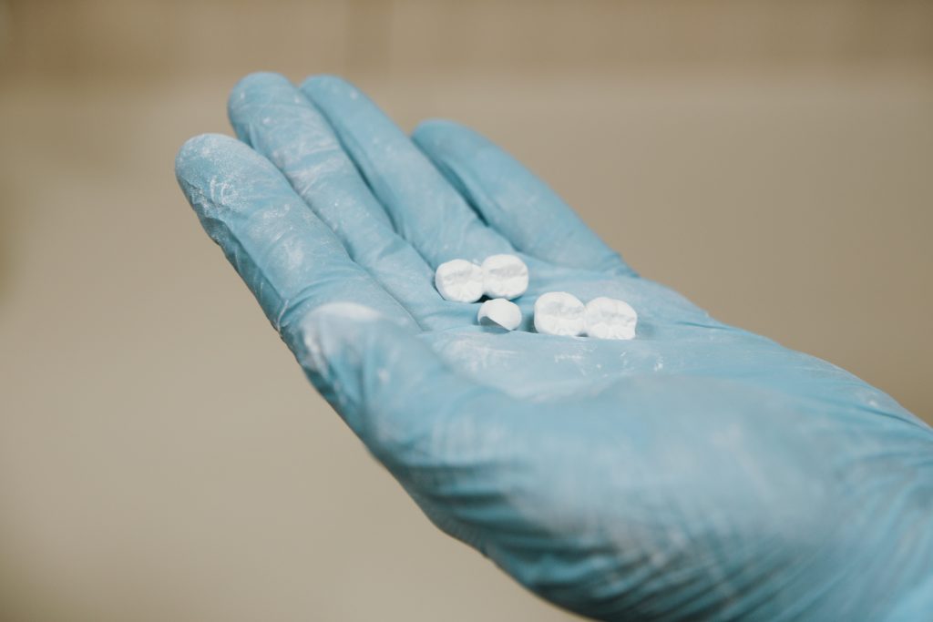 False teeth held by gloved hand